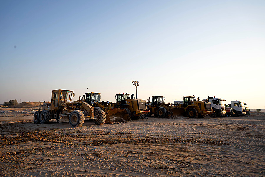 Loaders and graders at dusk